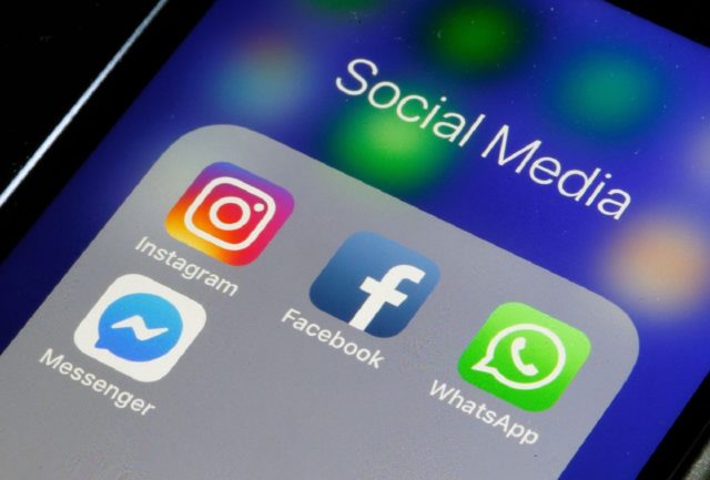 Zbliżenie na ekran smartfona z folderem "Social Media" zawierającym ikony aplikacji Instagram, Messenger, Facebook i WhatsApp.