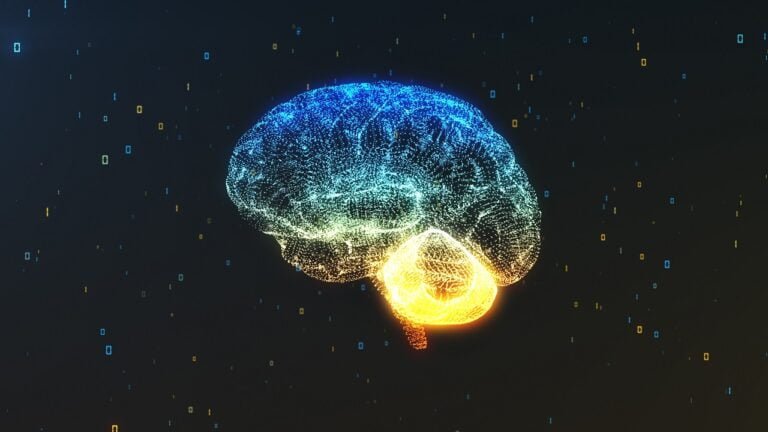 Cyfrowy obraz przedstawiający ludzki mózg i rdzeń kręgowy, utworzony z połączonych punktów świetlnych z dominującymi kolorami niebieskim i żółtym na ciemnym tle z rozproszonymi cyfrowymi elementami. Symbolizuje superkomputer działający jak ludzki mózg