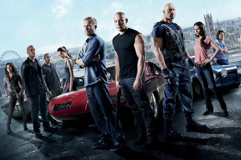 bohaterowie serii Szybcy i wściekli stojący przed sportowym samochodem
