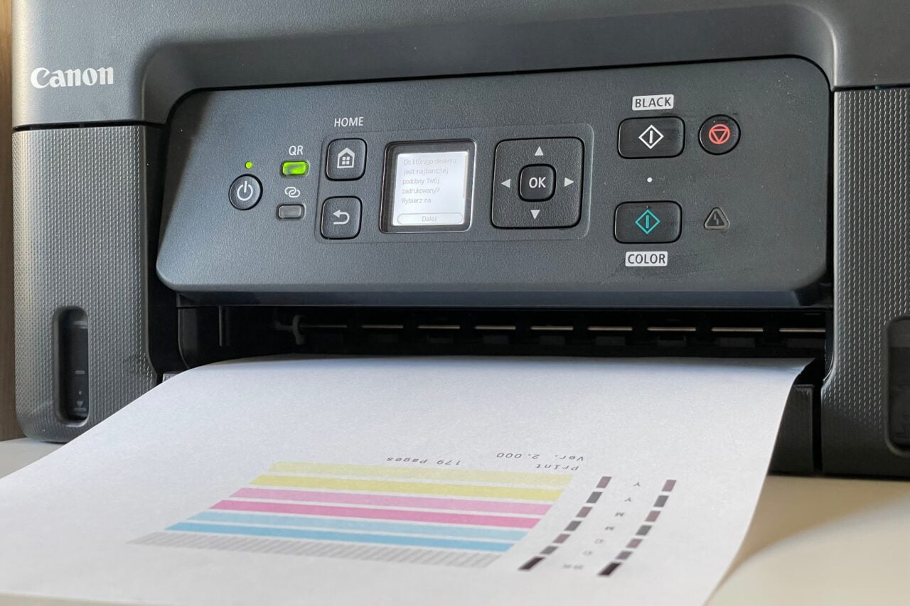 czarna drukarka canon drukująca testową stronę