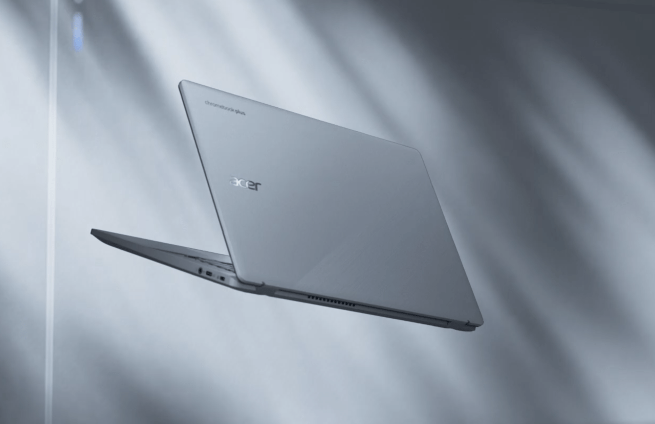 Laptop marki Acer ustawiony na boku na tle z rozmytymi liniami świetlnymi.