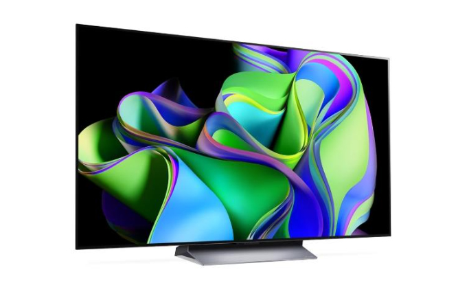Nowoczesny 55 calowy telewizor wyświetlający kolorową, abstrakcyjną grafikę.