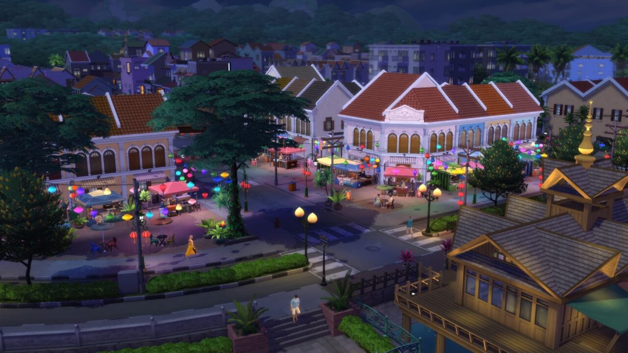 Na zdjęciu znajduje się kadr z gry The Sims 4. Widać na nim gęstą zabudowę miejską, z której wyróżnia się biały dom z czerwoną dachówką.