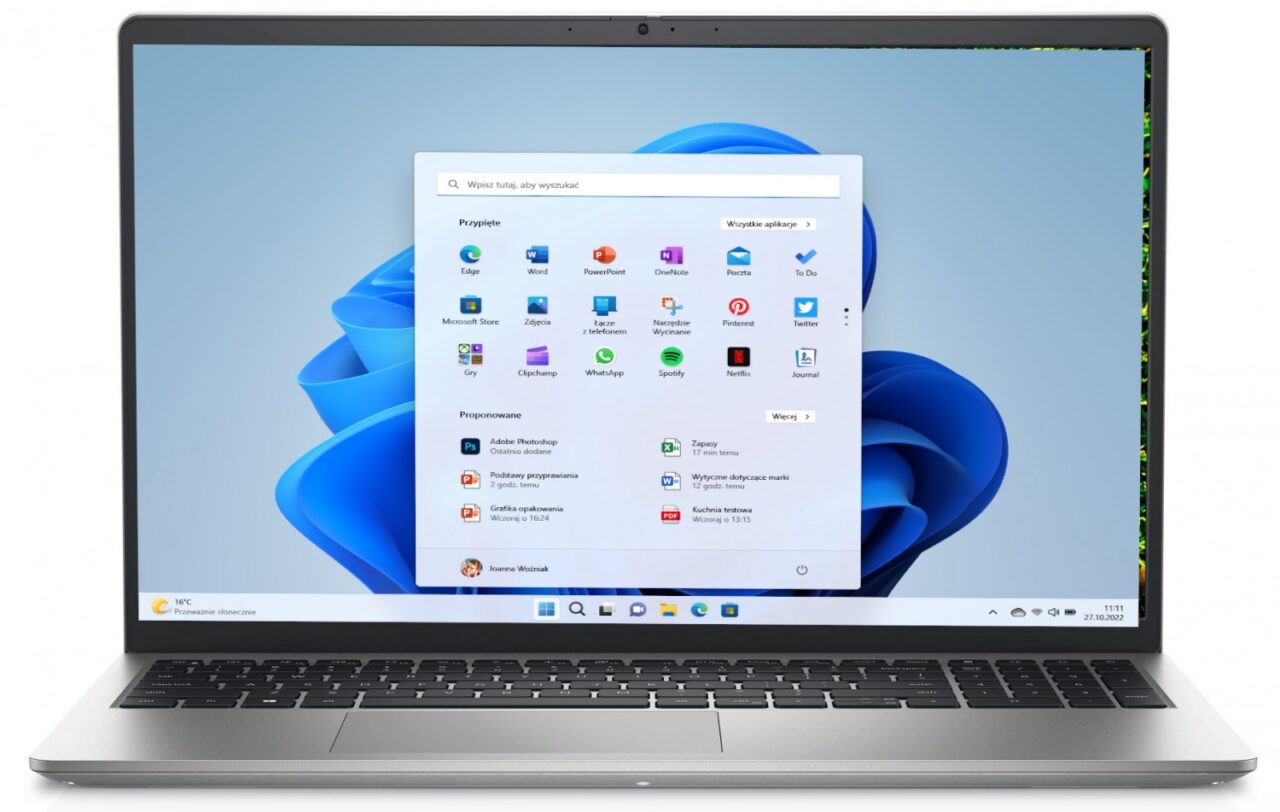 Laptop z otwartym menu Start systemu Windows z ikonami popularnych aplikacji i paskiem wyszukiwania na pierwszym planie.