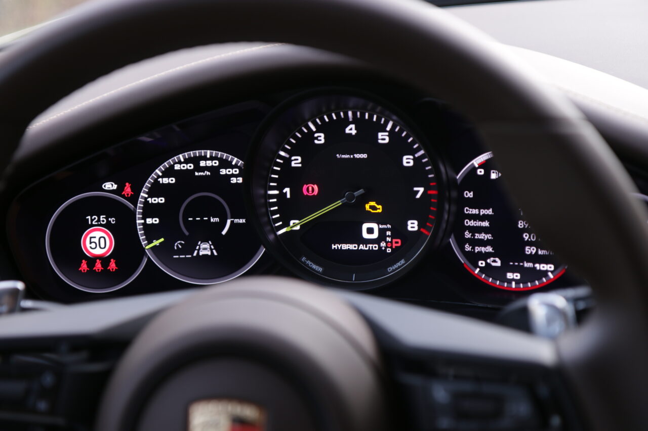 Cyfrowe zegary testowanego Porsche Panamera 4S E-Hybrid Sport Turismo częściowo zasłonięte przez kierownicę