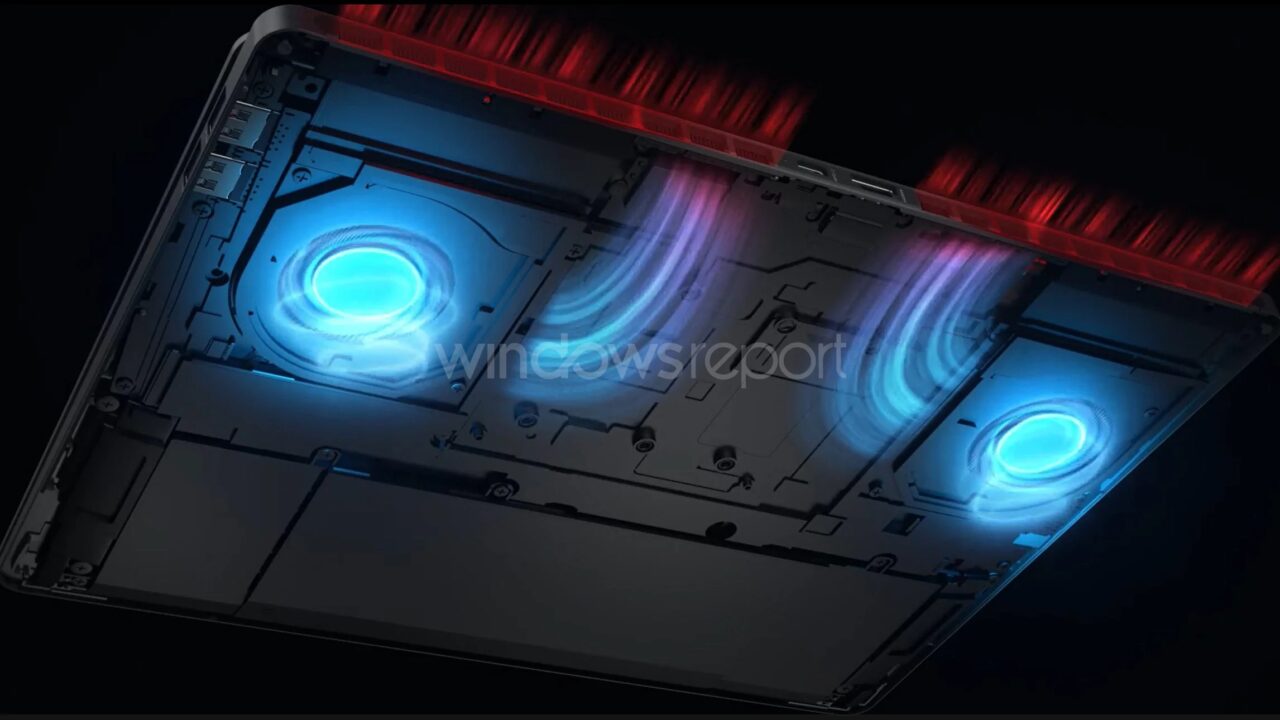 Podświetlany wnętrze laptopa gamingowego z widocznymi trzema niebieskimi wentylatorami chłodzącymi i czerwonymi elementami obudowy.