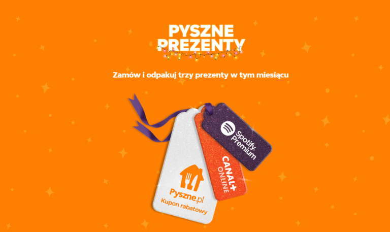 Trzy zawieszki w kształcie tagów na pomarańczowym tle z napisem "PYSZNE.PL PREZENTY" i mniejszym tekstem "Zamów i odpakuj trzy prezenty w tym miesiącu". Tagi przedstawiają logo Pyszne.pl, Spotify Premium i CANAL+ online.