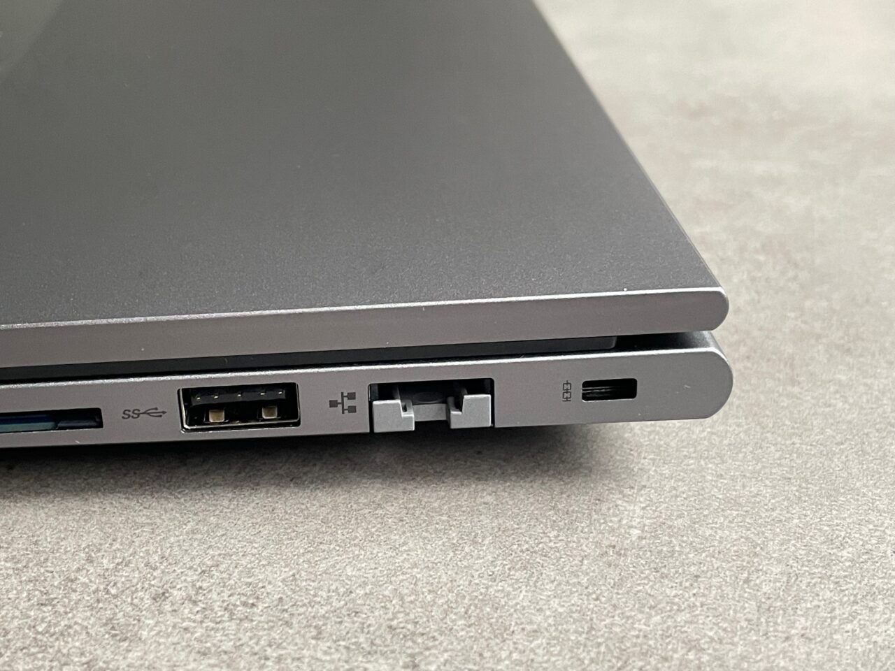 Część boczna laptopa z widocznymi portami: USB, HDMI, karta SD oraz złączem zasilania.