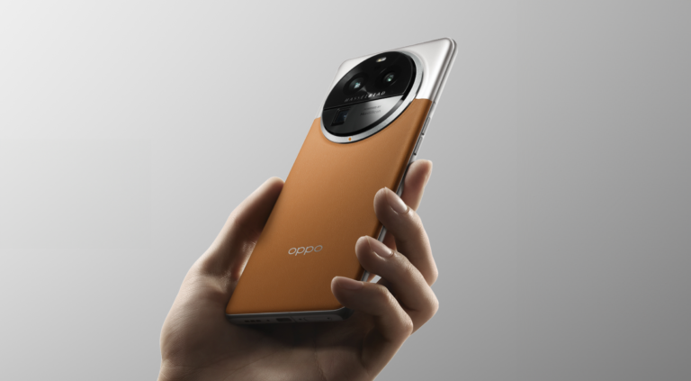 Dłoń trzymająca smartphone marki Oppo w kolorze pomarańczowym z dużym modułem aparatu fotograficznego i logo Hasselblad na tylnej stronie.
