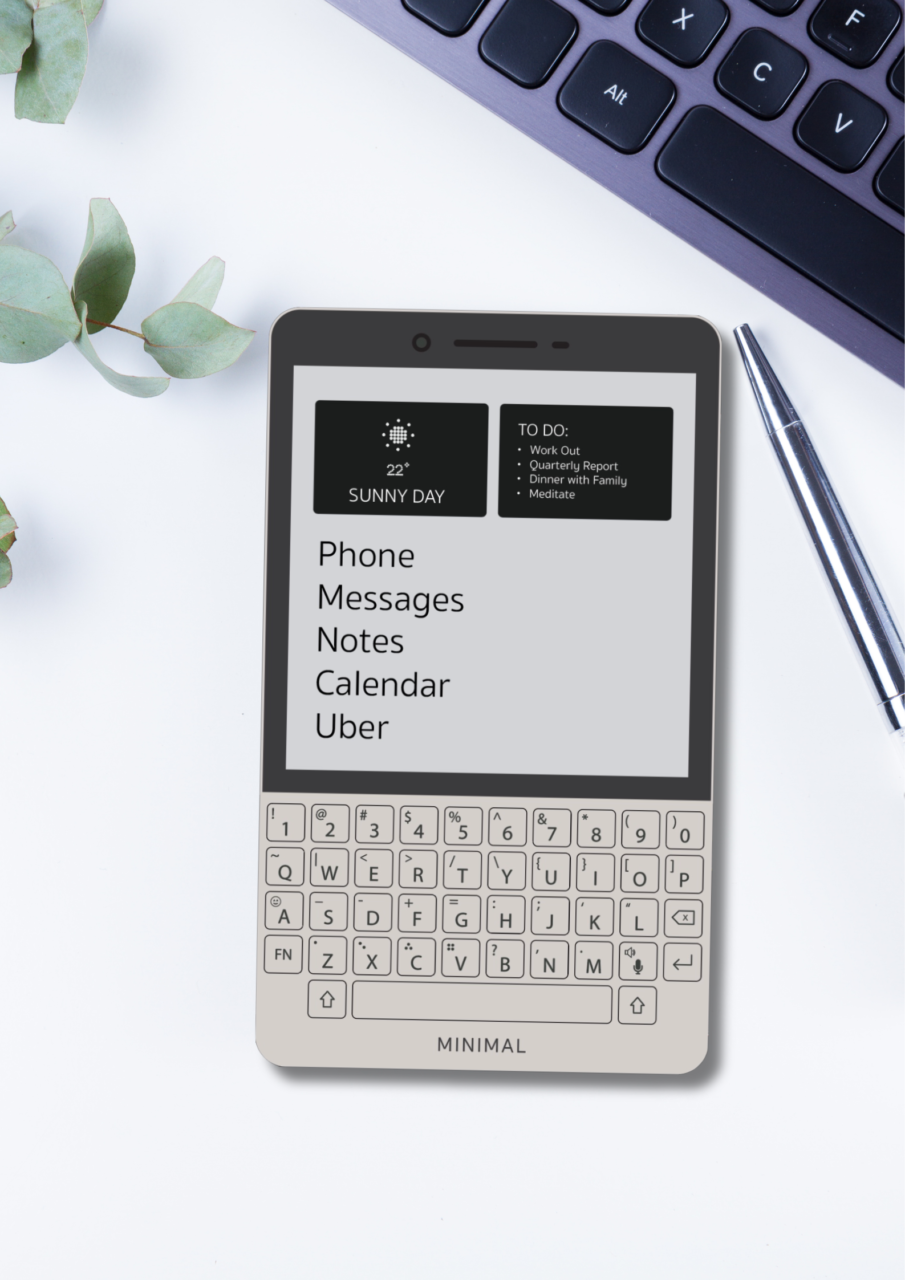 Smartfon Minimal z wyświetlaczem menu i listą zadań, leżący na biurku obok klawiatury i długopisu, z elementami roślinnymi w tle.