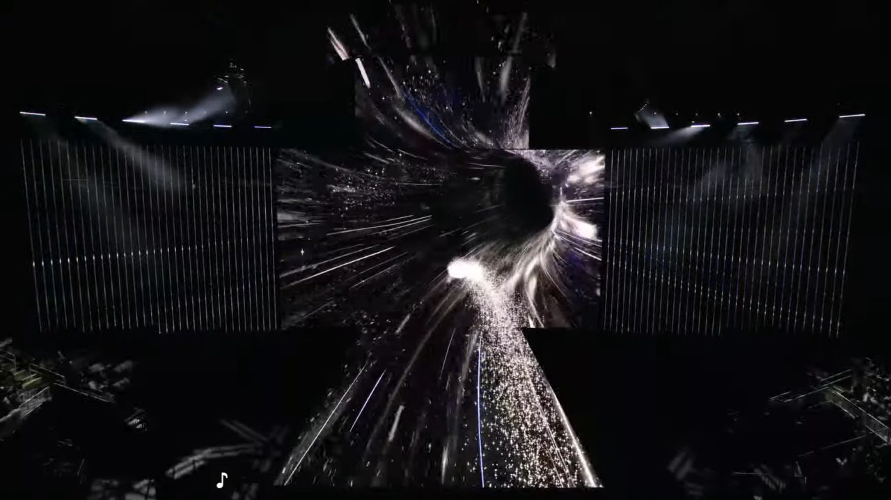 Samsung Unpacked 2024. Dynamiczne wizualizacje świetlne symulujące podróż przez kosmos, wyświetlane na ekranach scenicznych podczas koncertu.