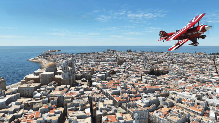 Samolot akrobacyjny z gry Microsoft Flight Simulator nad gęsto zabudowanym miastem przy wybrzeżu.