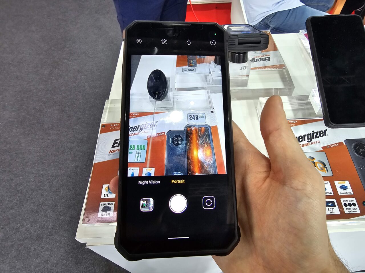Dłoń trzymająca smartfon Energizer Hard Case P28K, którego ekran pokazuje wyświetlacz z ceną telefonu marki Energizer.
