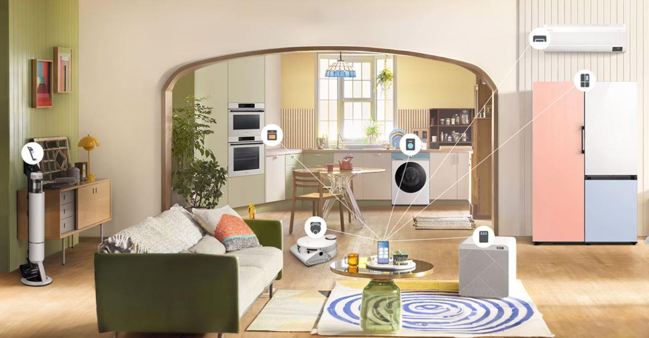Wnętrze nowoczesnego salonu połączonego z kuchnią z widocznymi inteligentnymi urządzeniami domowymi, takimi jak odkurzacz robot, system klimatyzacji i elektronika użytkowa.