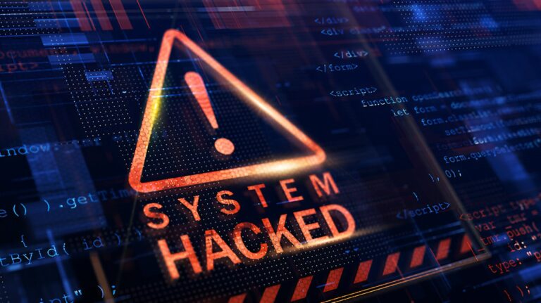 Ataki ransomware, takie jak wyciek z ALAB, wywołują ostrzeżenie o zhakowanym systemie z ikoną wykrzyknika na tle z kodem programistycznym.