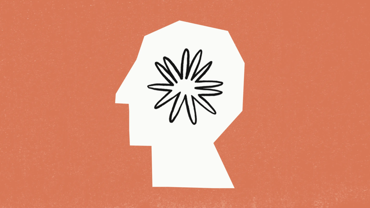Ilustracja przedstawiająca biały sylwetkowy profil głowy z czarno-białym kwiatem w środku, na pomarańczowym tle.