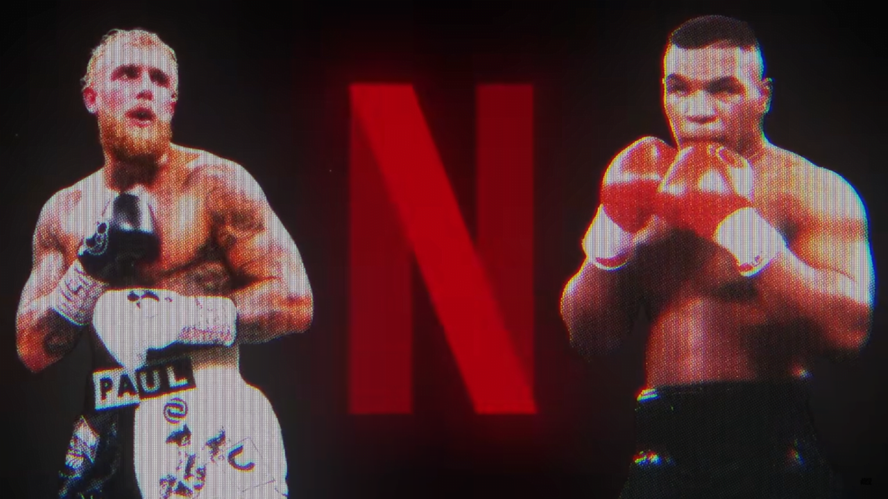 Jake Paul i Mike Tyson. Dwaj bokserzy w pozycji bojowej z dużą czerwoną literą "N" w tle.