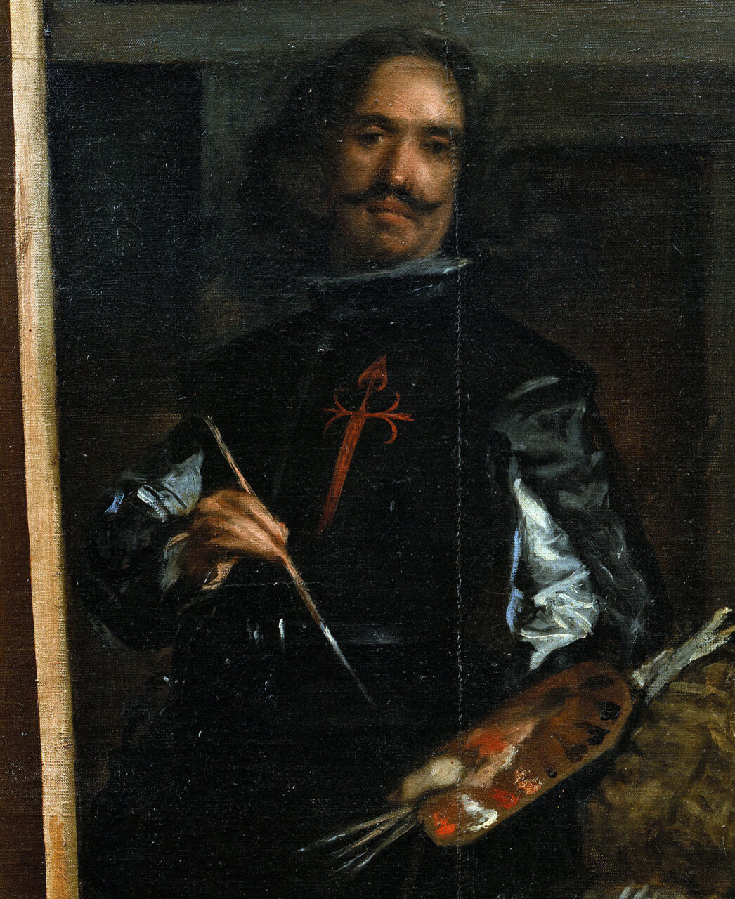 Portret mężczyzny trzymającego paletę i pędzelek, noszącego czarny strój z czerwonym krzyżem.