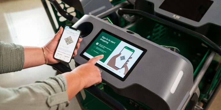 Osoba skanuje kod QR na telefonie komórkowym przy samoobsługowym terminalu checkout.