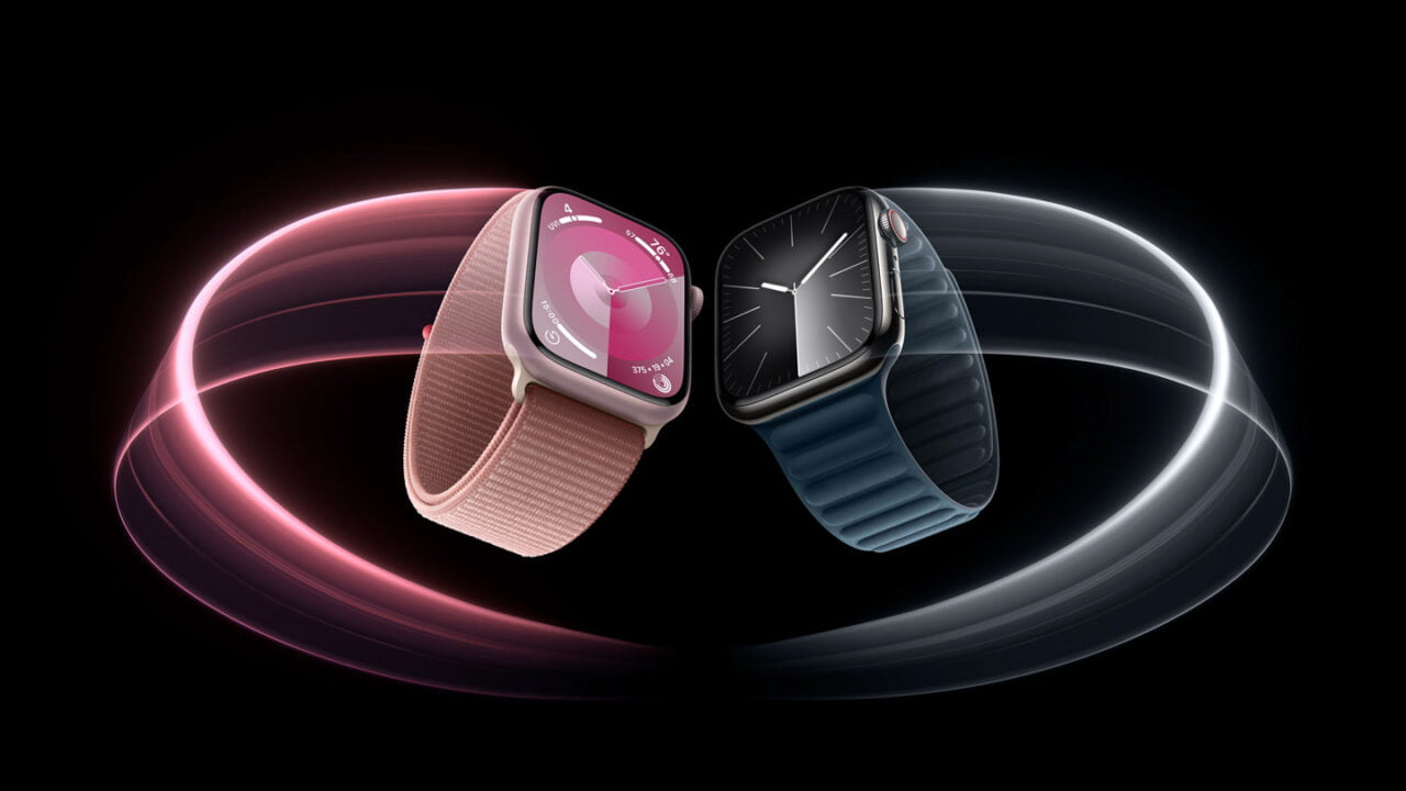 Dwa inteligentne zegarki z paskami w kolorze różowym i granatowym prezentowane z dynamicznymi, świetlistymi pętlami w tle na czarnym tle.