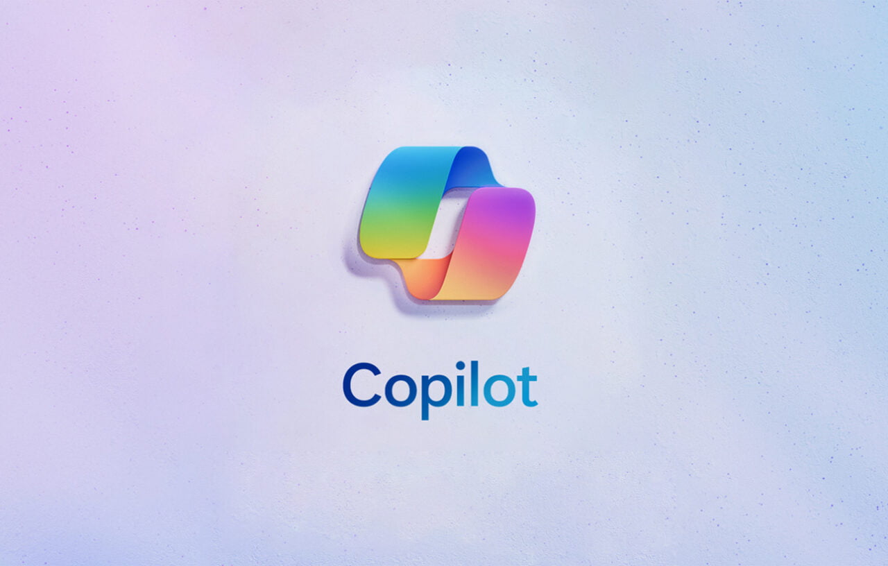 Logotipo "Co-piloto" em forma de bloco tridimensional irregular com gradiente de cor, sobre fundo com textura semelhante a areia fina.