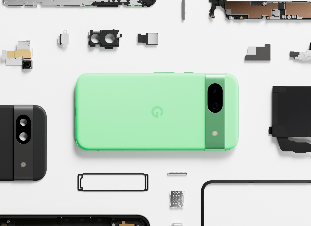Um smartphone verde com peças eletrônicas desmontadas de vários dispositivos dispostos sobre um fundo branco.