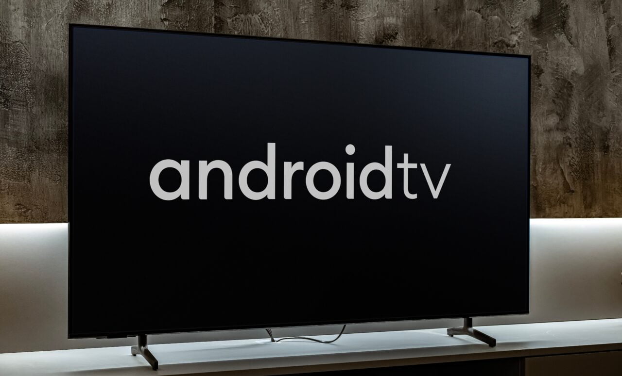 Obraz w obrazie - Telewizor z logo Android TV 14 na ekranie, ustawiony na półce.