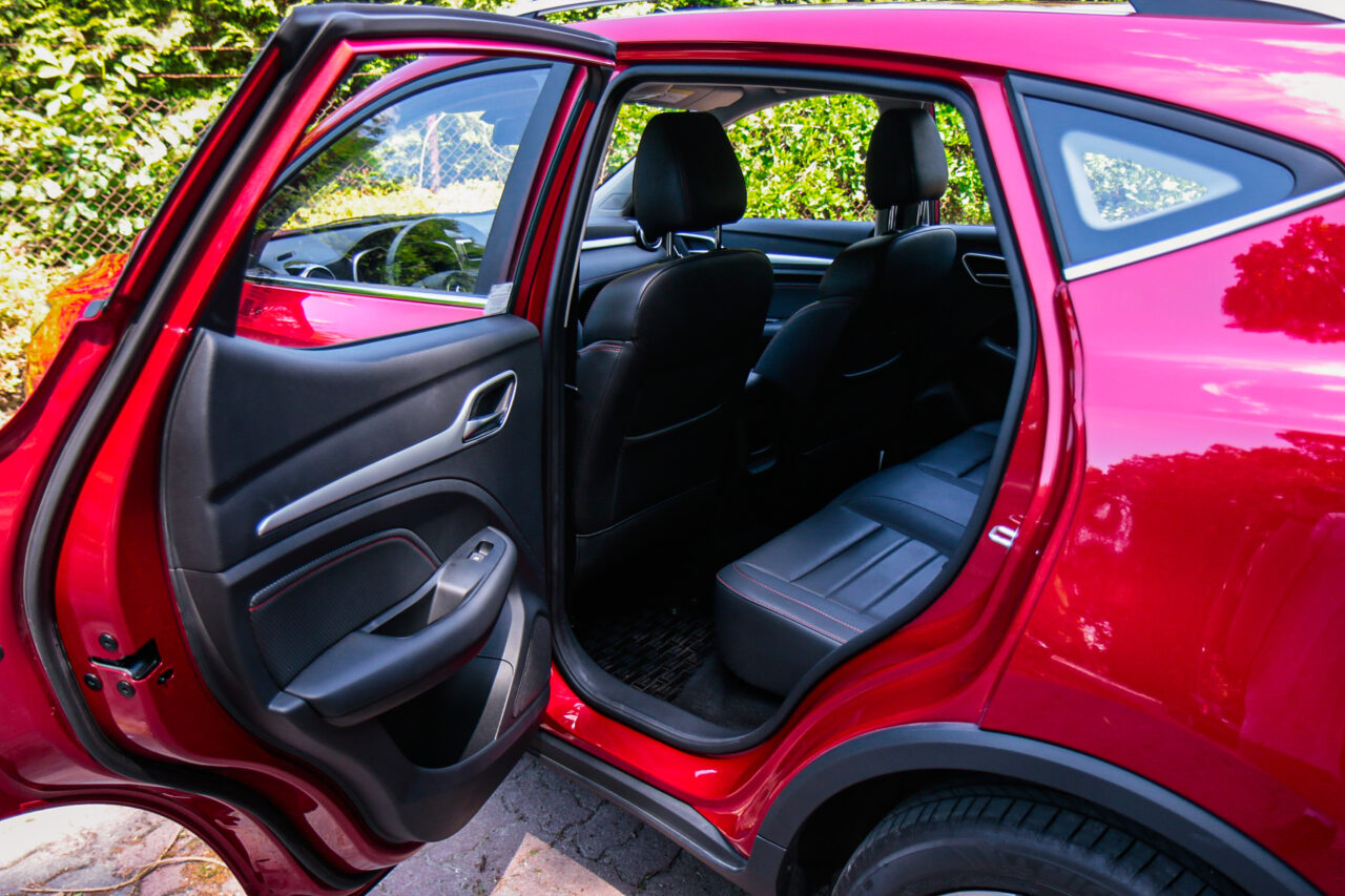 Czerwony samochód MG ZS, test MG ZS, otwarte tylne drzwi, widok na wnętrze tylnego siedzenia.