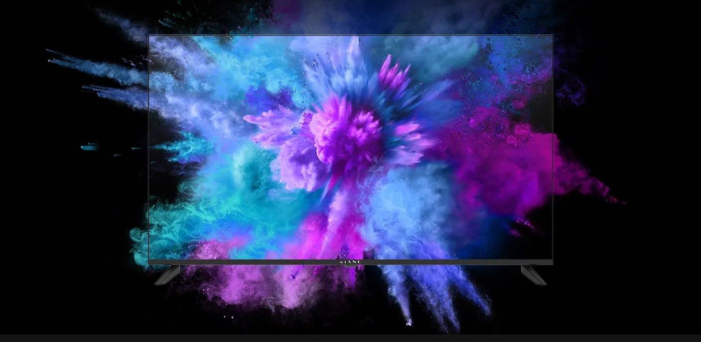 Telewizor z kolorowymi wybuchami farby na ekranie na czarnym tle.