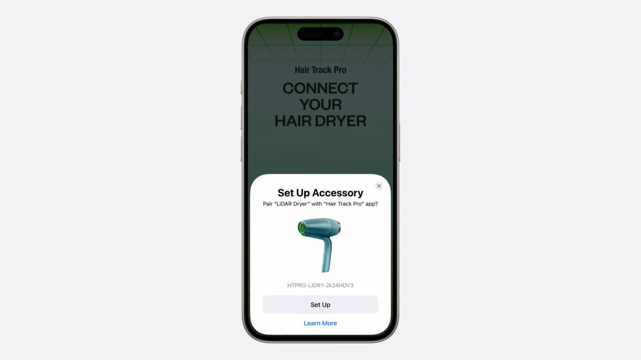Telefon z widokiem aplikacji na łączenie suszarki do włosów, z przyciskiem "Set Up" i obrazem suszarki.