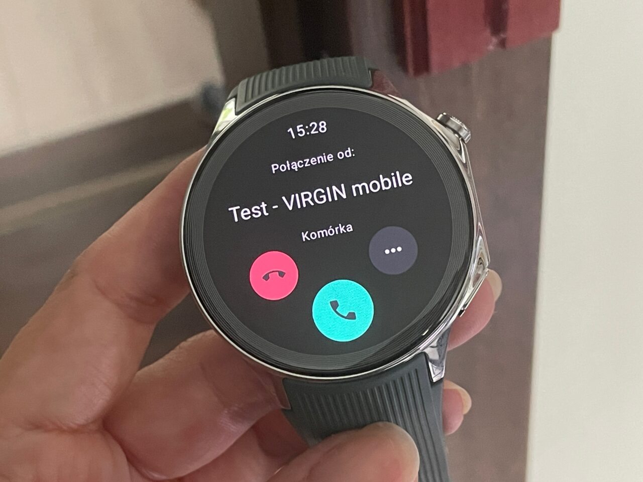 Smartwatch z wyświetlonym ekranem połączenia telefonicznego od "Test - VIRGIN mobile".