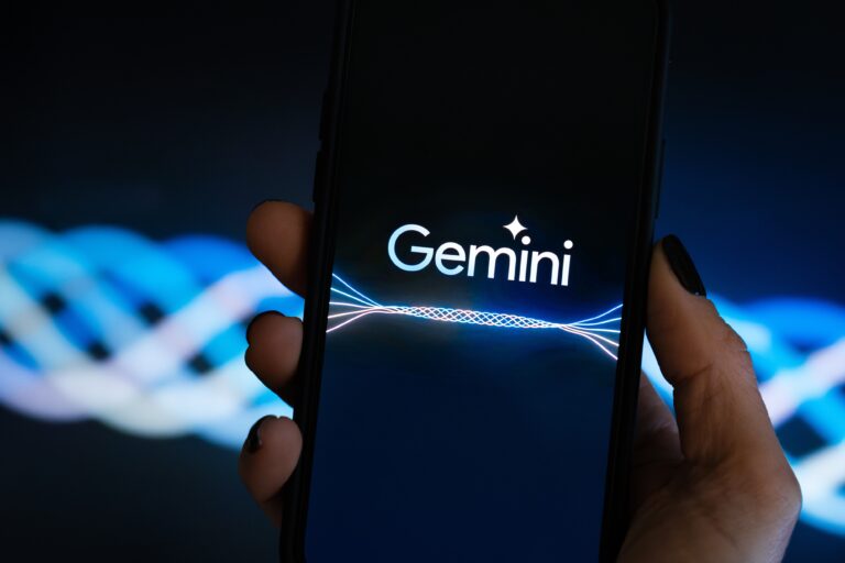Logo Google Gemini na ekranie telefonu trzymanego w ręce.