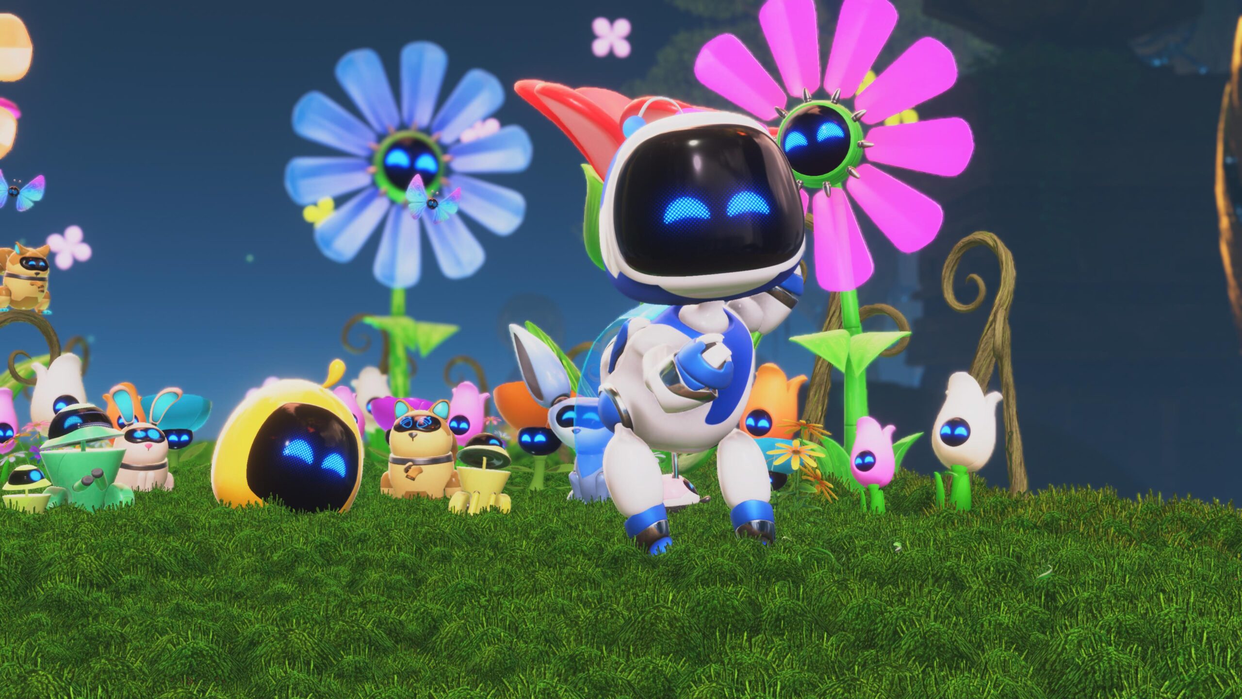 ASTRO BOT w otoczeniu kolorowych kwiatów i innych małych robotów na tle trawy.