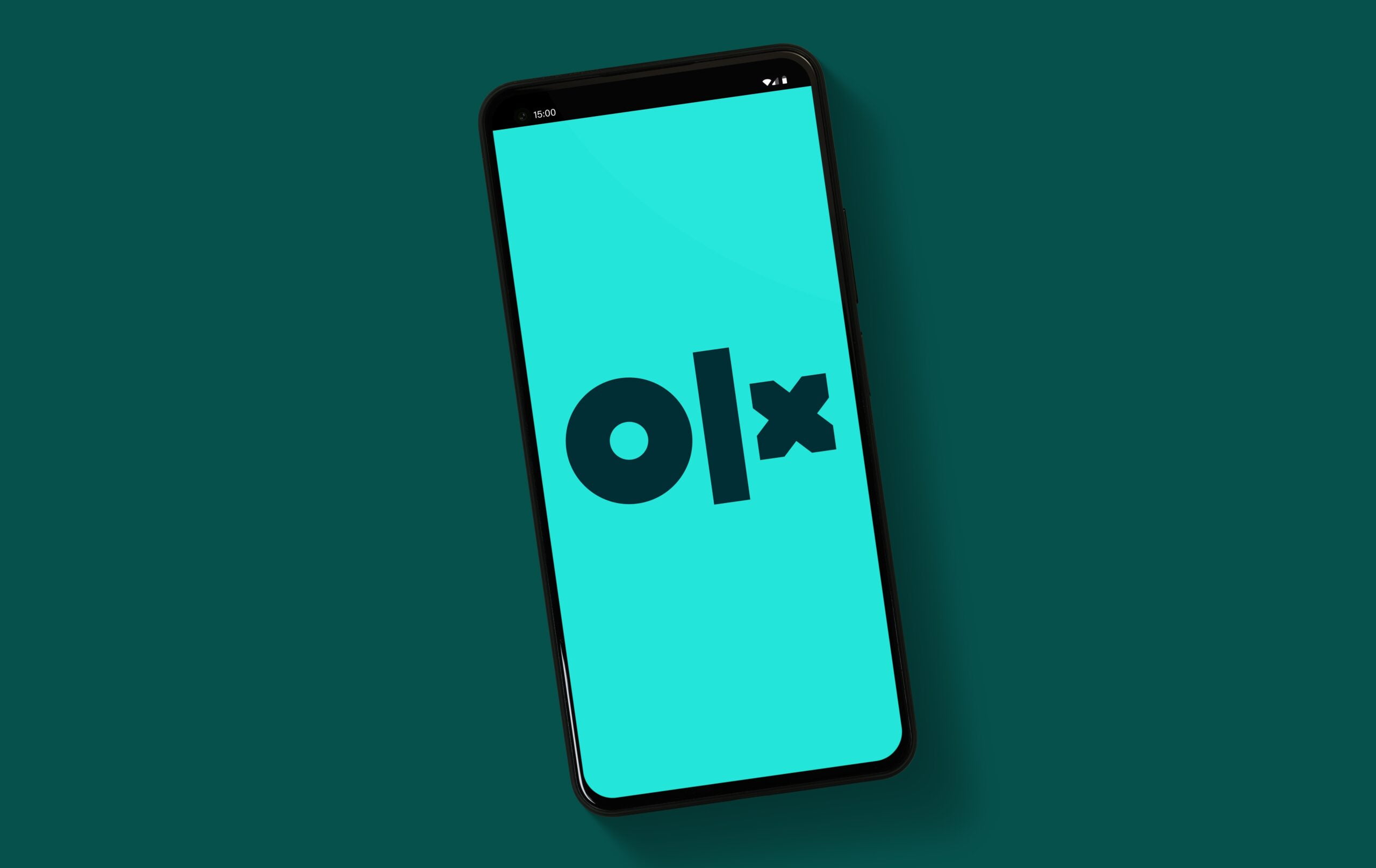 Smartfon z logo OLX na ekranie.