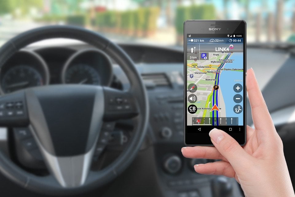 Smartphone with map gps navigation app on the screen in female h